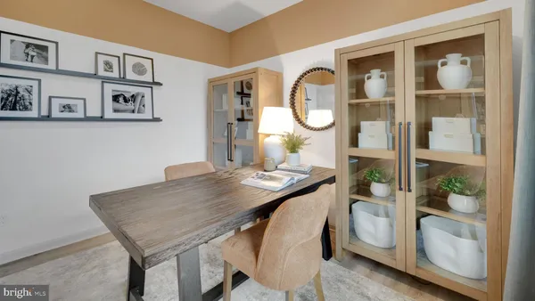 a view of a dining room with furniture and front door