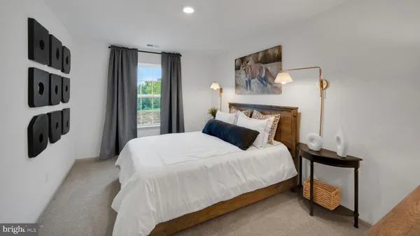 a bedroom with a bed and a painting on the wall