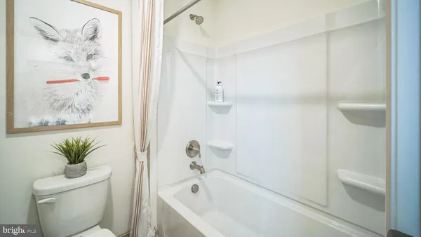 a bath room with a toilet and a bath tub