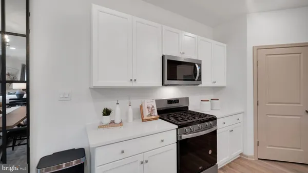 a kitchen with appliances a sink and cabinets