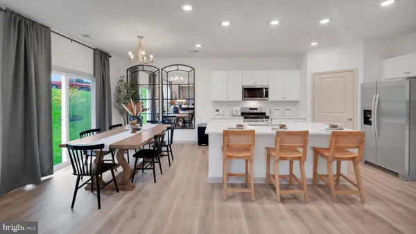 a dining room with furniture window and wooden floor