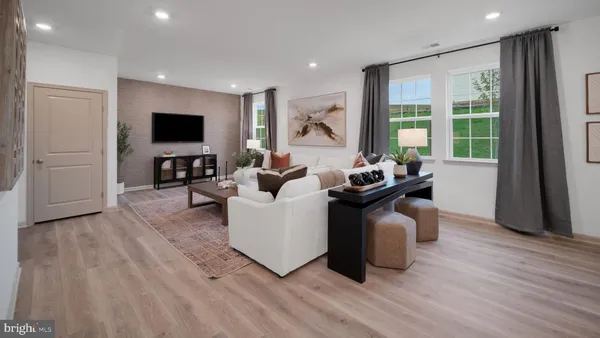 a living room with furniture a flat screen tv and a large window