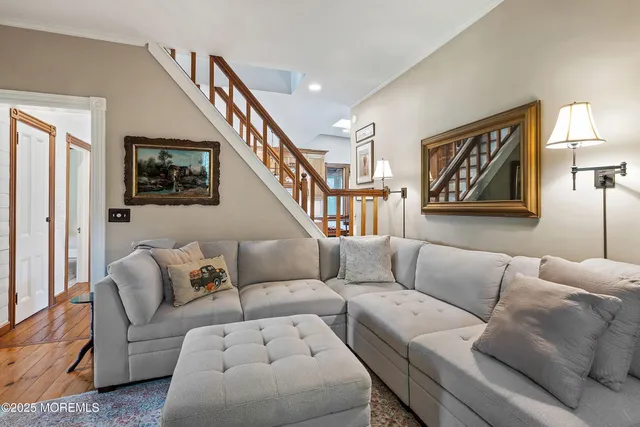 a dining hall with stainless steel appliances granite countertop a dining table and chairs with wooden floor