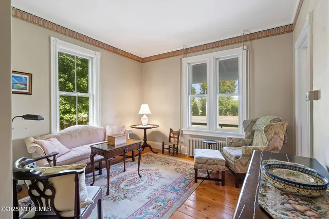 a room with furniture a flat screen tv and entryway