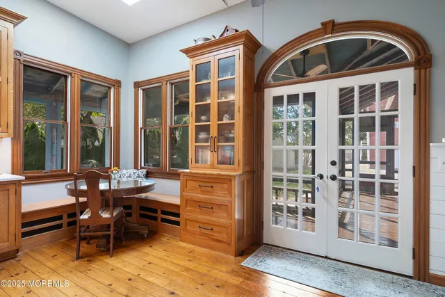 a living room with furniture a dining table and a window