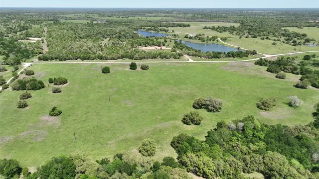 an aerial view of a houses with a yard