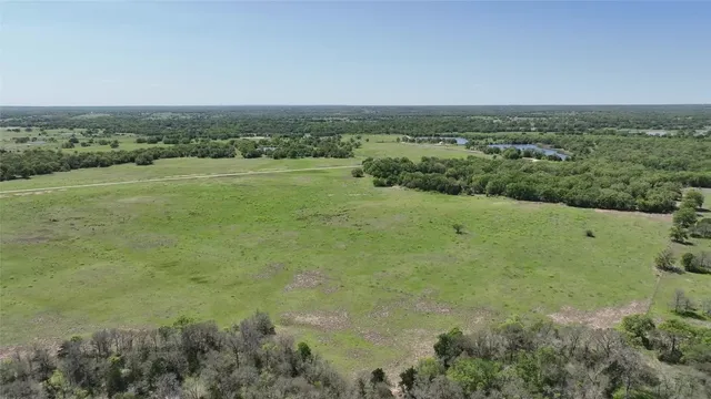 a view of a lake with green field