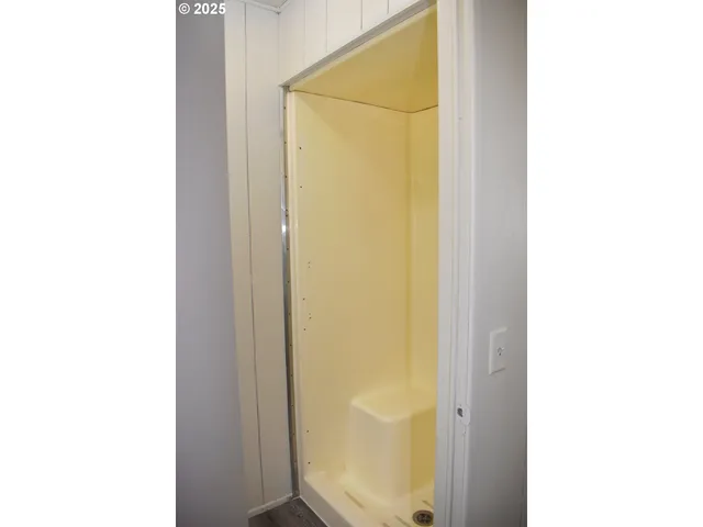 a picture of a bathroom with a shower