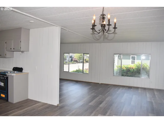 a view of a room with wooden floor and windows