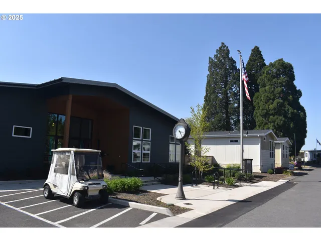 a living room with fireplace furniture and a large window