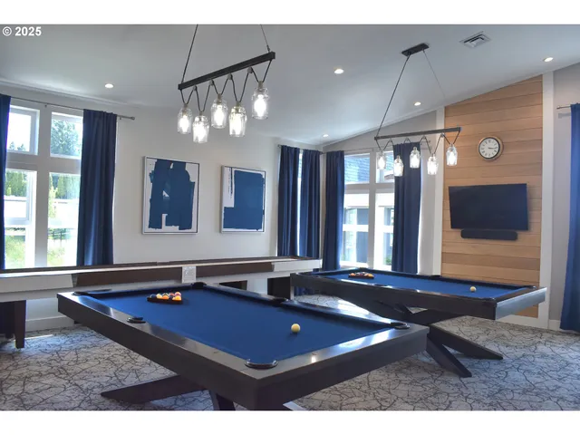 a living room with furniture a window and flat screen tv