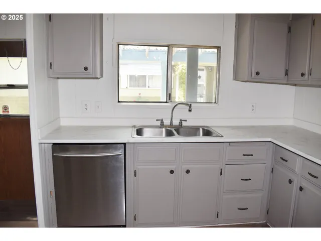 a kitchen with white cabinets and a sink