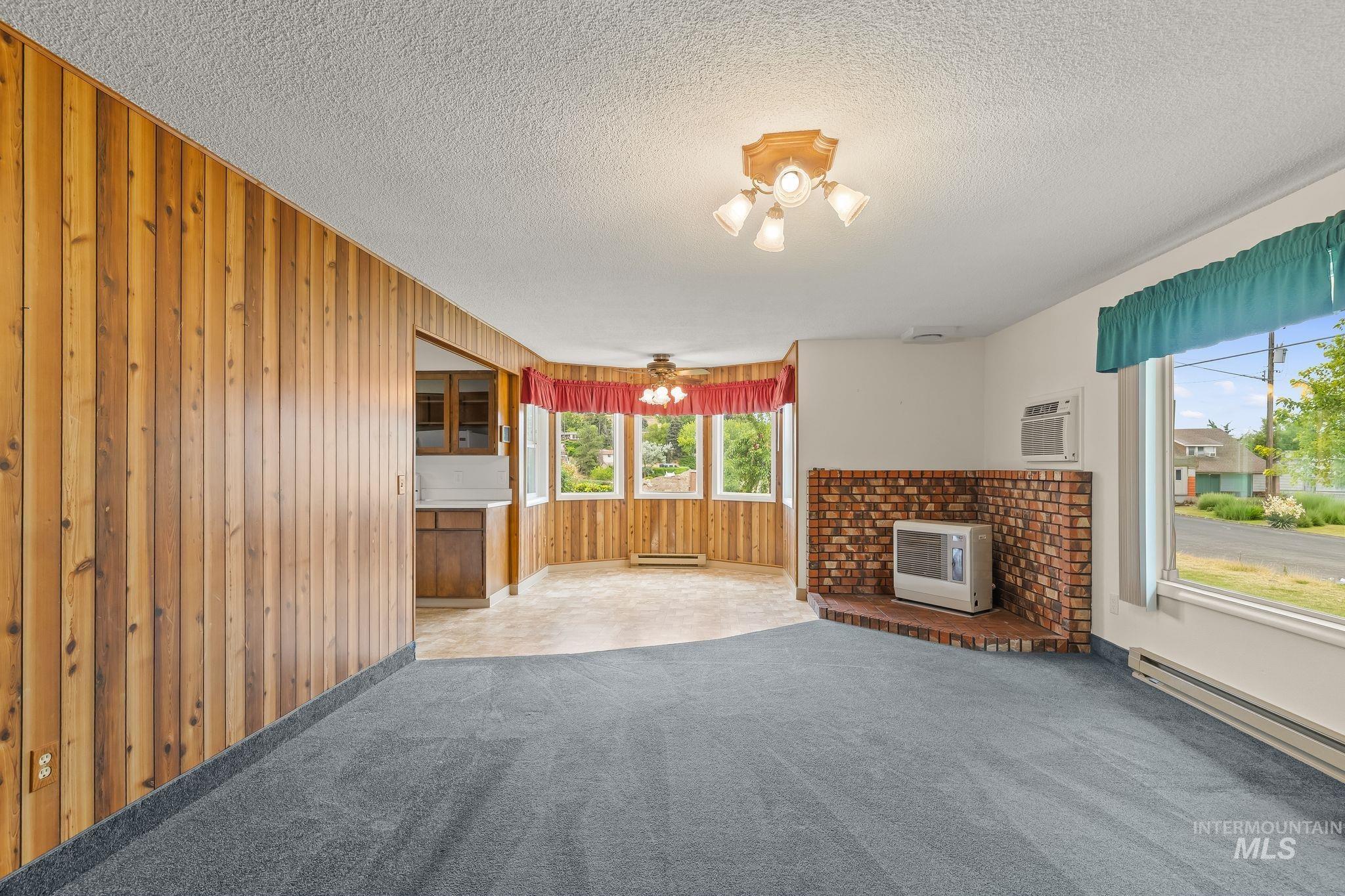 1721 3rd Street Lewiston, ID 83501 - Photo 30 of 45 Interior space featuring blue carpeting, a brick-faced hearth, and multiple windows