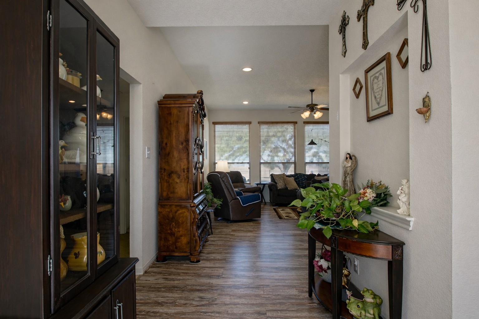 9439 Jeske Road Needville, TX 77461 - Photo 12 of 48 a hallway with painting on the wall and a potted plant