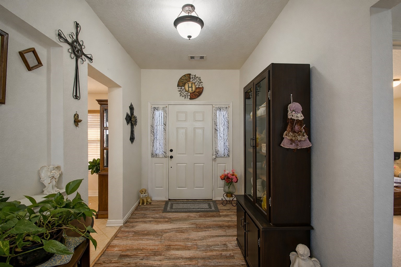 9439 Jeske Road Needville, TX 77461 - Photo 13 of 48 a view of a hallway with wooden floor and entryway