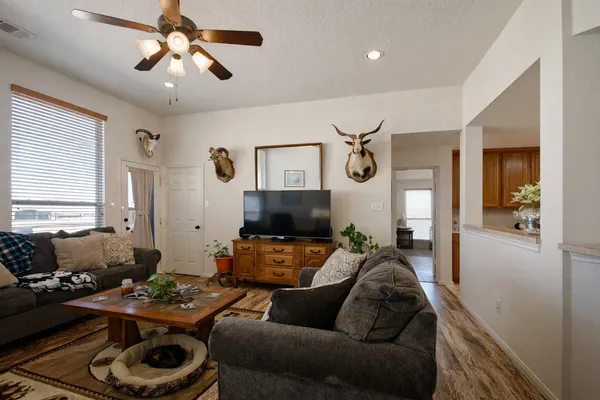 a bedroom with a bed a chandelier and dresser
