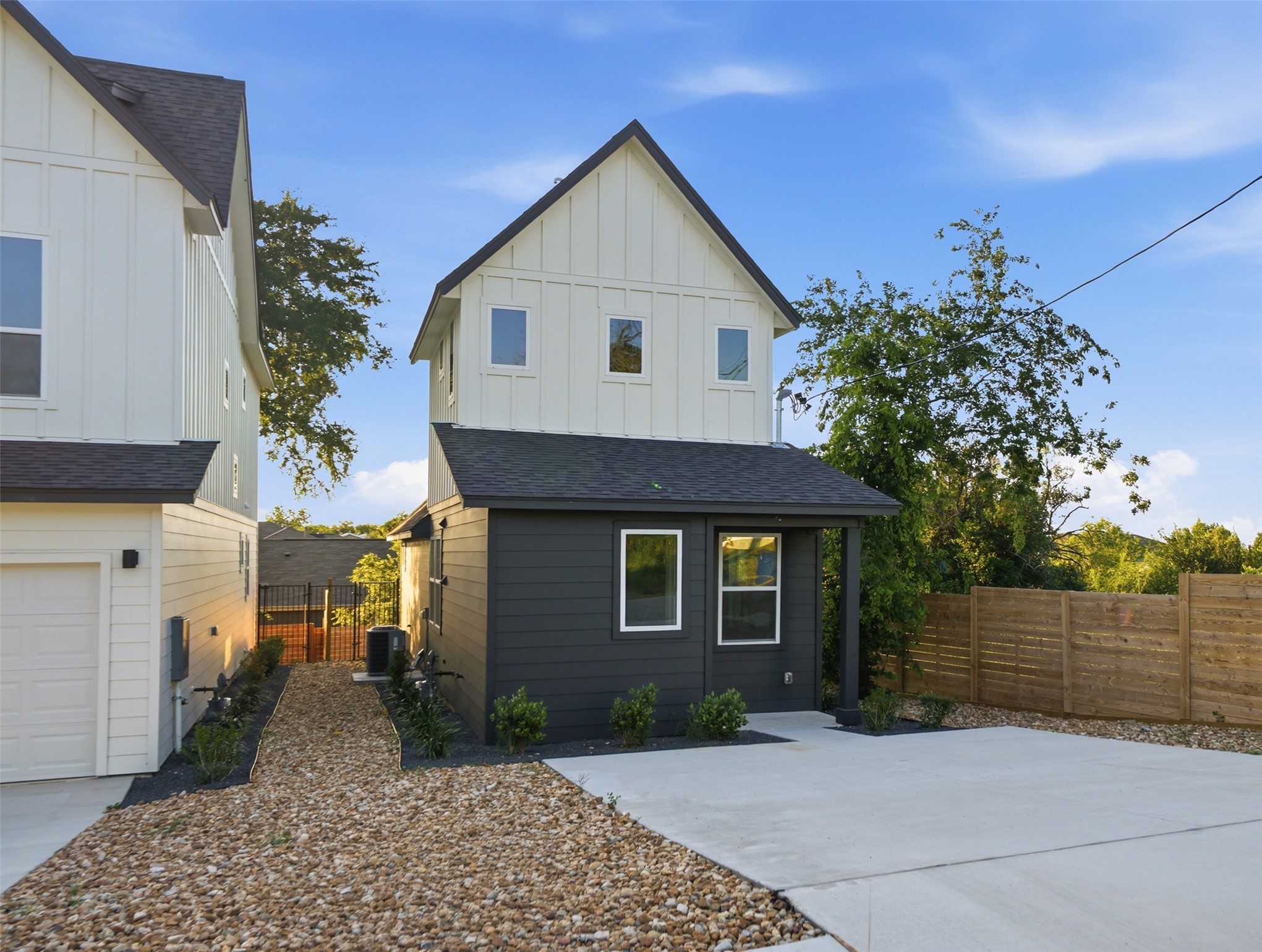 2212 Yellow Jacket Lane, Unit 2 Austin, TX 78741 - Photo 2 of 25 Contemporary residence featuring a two-tone exterior with white board-and-batten siding and dark horizontal siding