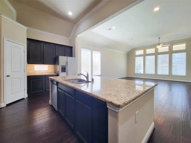 a kitchen with stainless steel appliances granite countertop refrigerator sink and cabinets