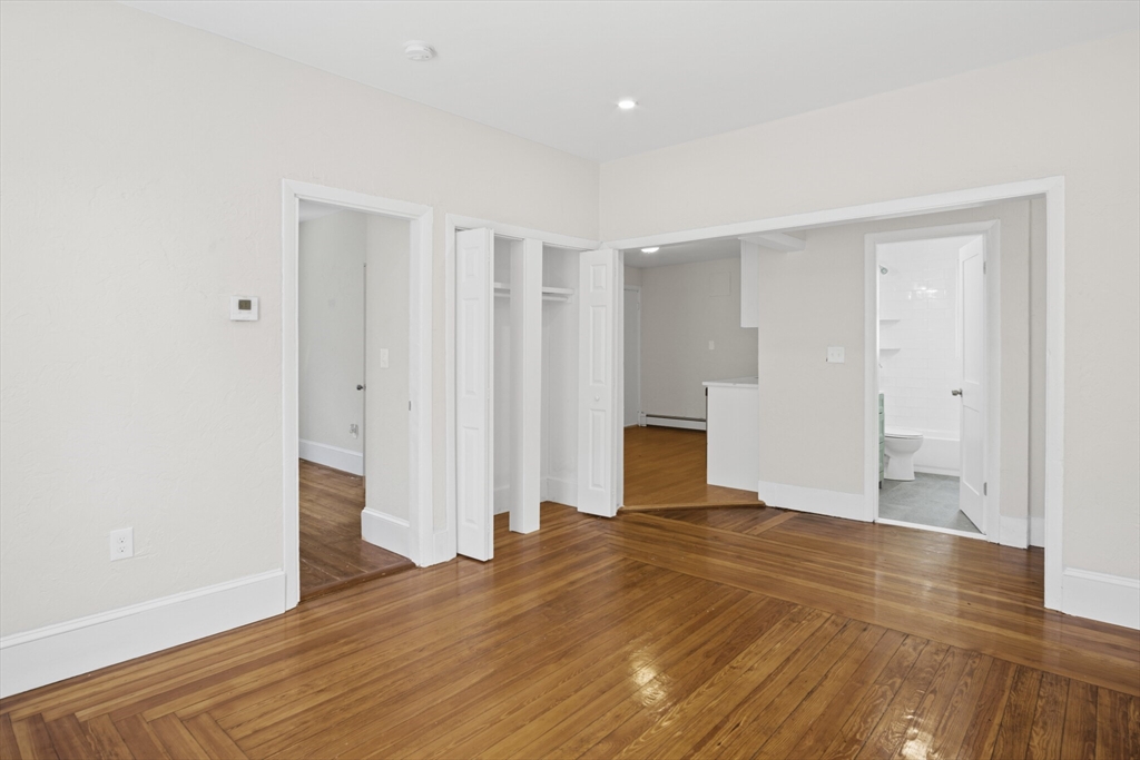 10 Redfield Street, Unit 2 Boston, MA 02122 - Photo 7 of 10 a view of a bedroom with wooden floor and bathroom