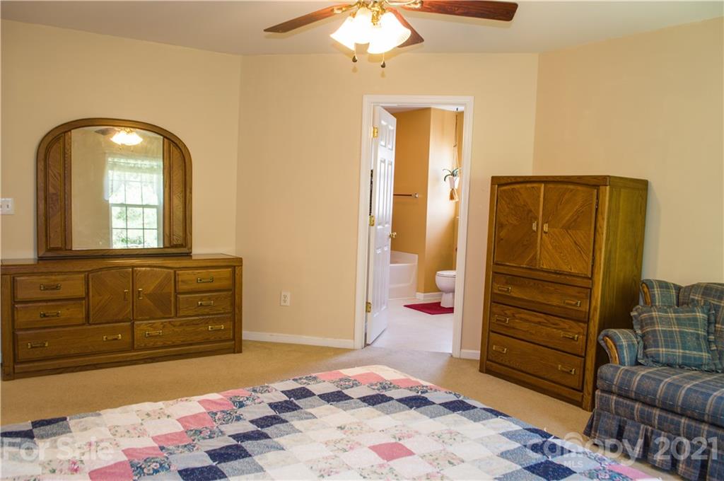 144 Amber Woods Drive Tega Cay, SC 29708 - Photo 11 of 37 a bedroom with a bed and a dresser