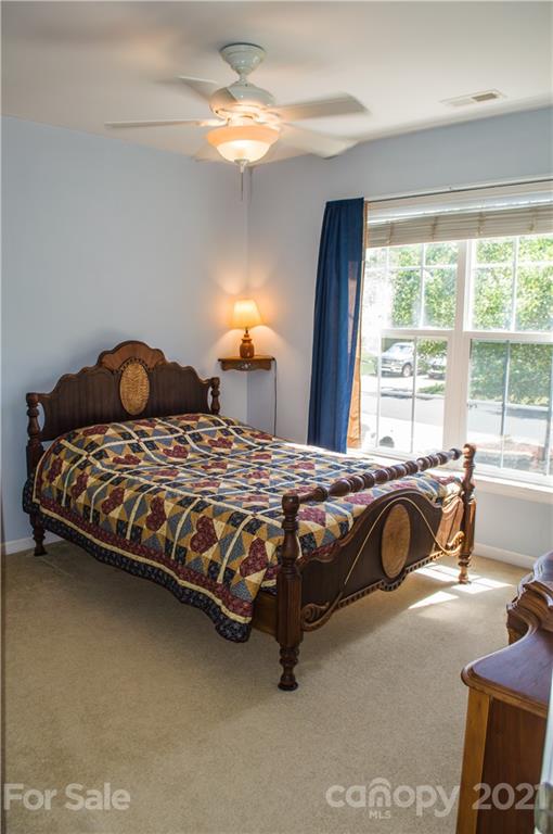 144 Amber Woods Drive Tega Cay, SC 29708 - Photo 15 of 37 a bedroom with a bed and a couch