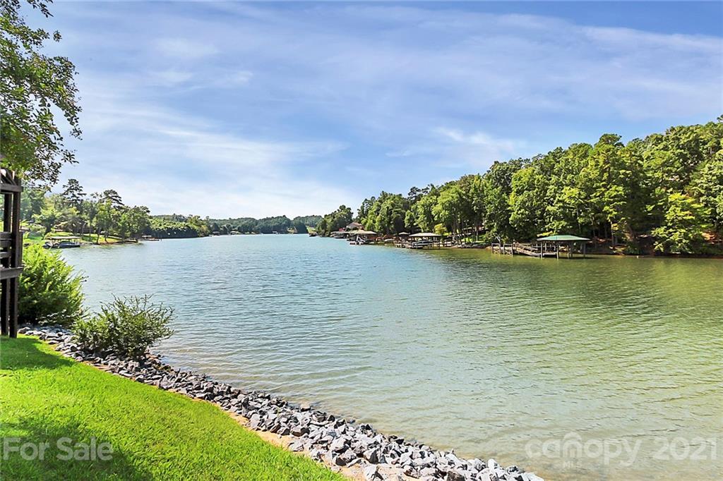 144 Amber Woods Drive Tega Cay, SC 29708 - Photo 32 of 37 a view of a lake with a big yard