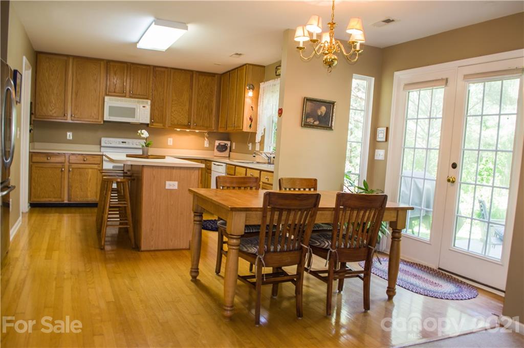144 Amber Woods Drive Tega Cay, SC 29708 - Photo 6 of 37 a view of a dining room with furniture and wooden floor