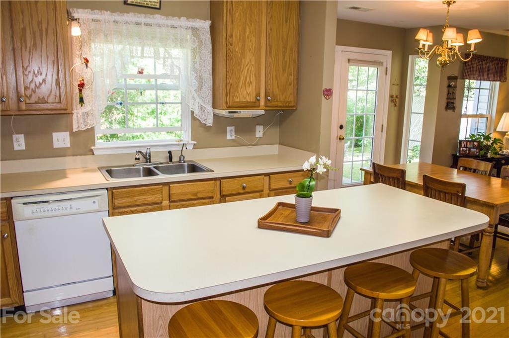 144 Amber Woods Drive Tega Cay, SC 29708 - Photo 7 of 37 a kitchen with a table chairs sink and cabinets