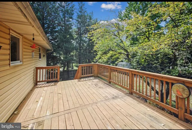 a view of balcony with wooden floor and fence