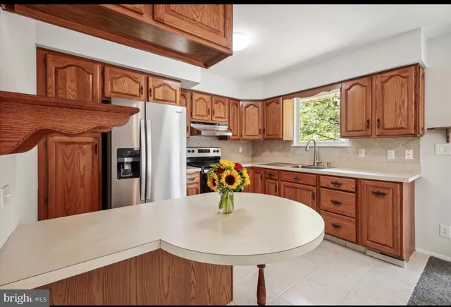 a kitchen with stainless steel appliances a refrigerator sink and cabinets