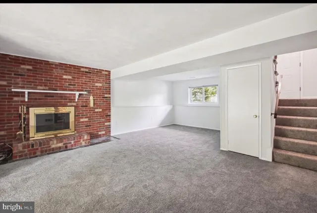 a view of empty room with a fireplace