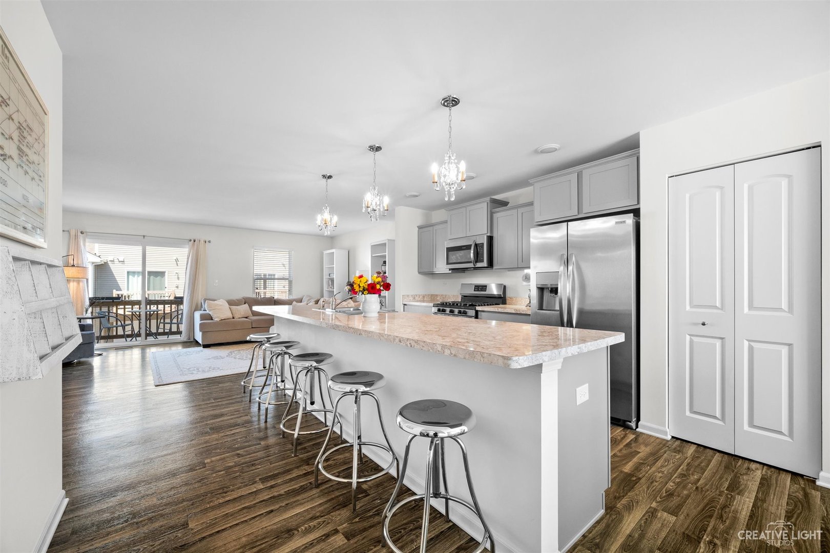 2342 Upland Road Pingree Grove, IL 60140 - Photo 6 of 22 a kitchen with a dining table chairs refrigerator wooden floor and cabinets