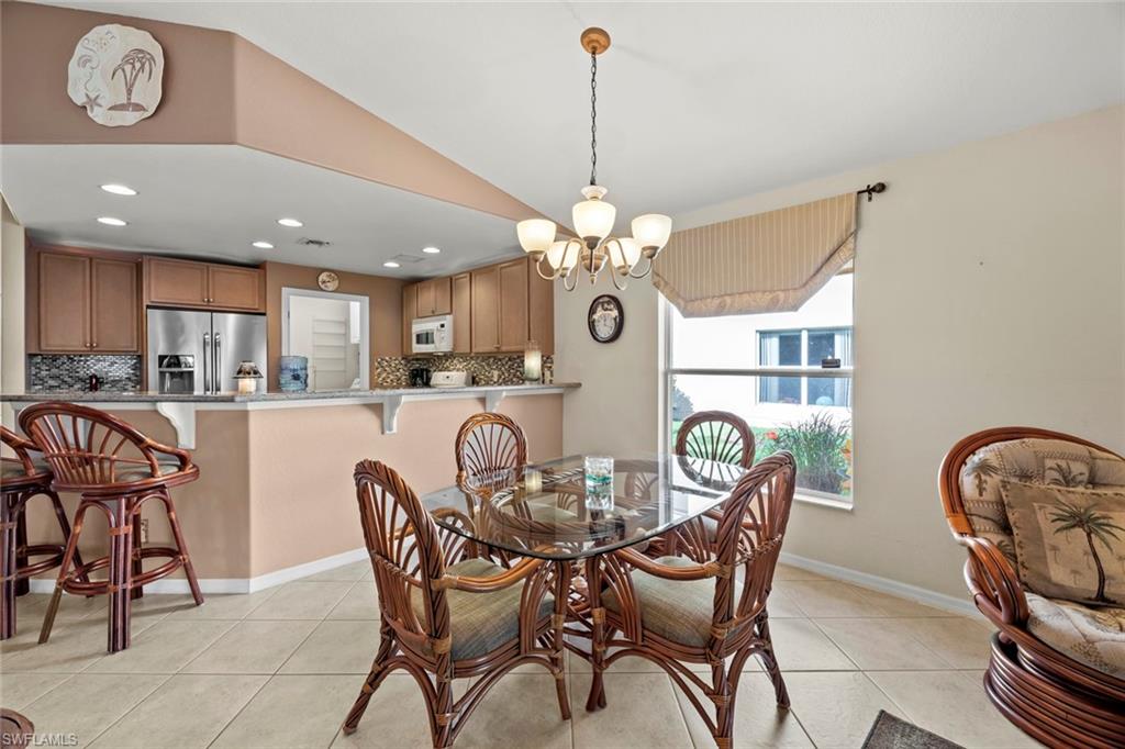 19647 Villa Rosa Loop Estero, FL 33967 - Photo 14 of 48 a dining room filled chandelier and wooden floor