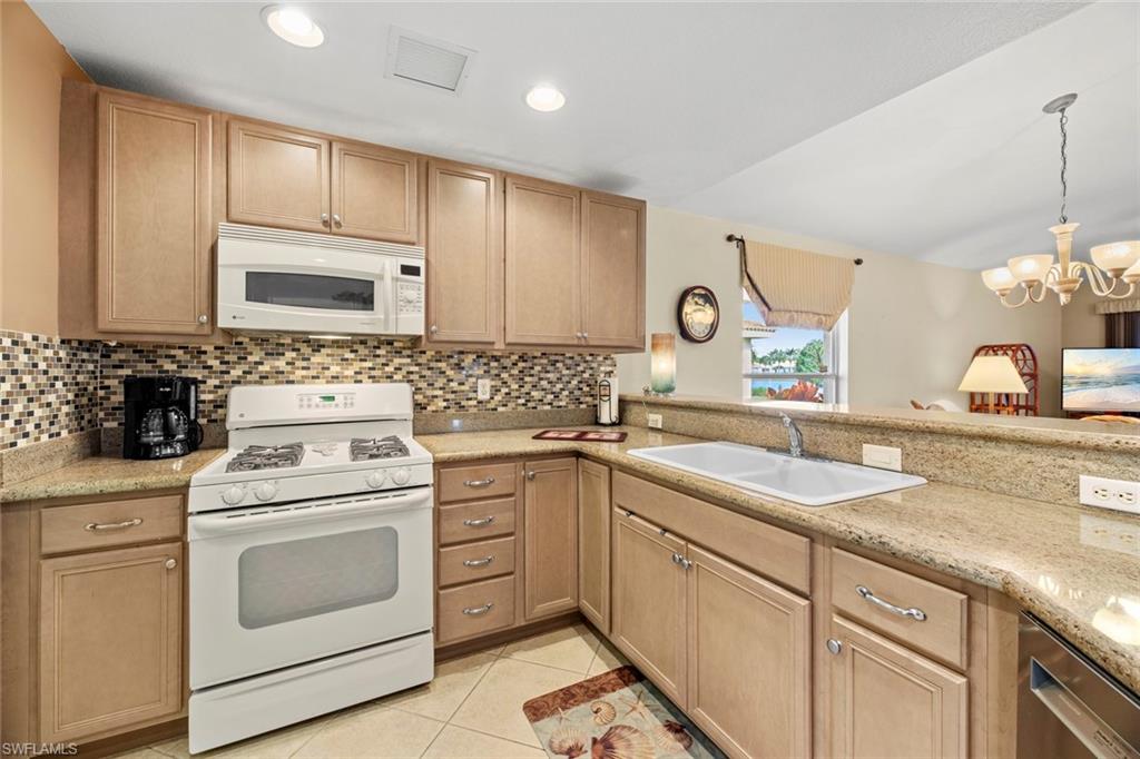 19647 Villa Rosa Loop Estero, FL 33967 - Photo 20 of 48 a kitchen with cabinets appliances a sink and a counter top space