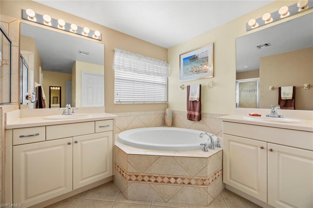 19647 Villa Rosa Loop Estero, FL 33967 - Photo 23 of 48 a bathroom with a tub sink and mirror