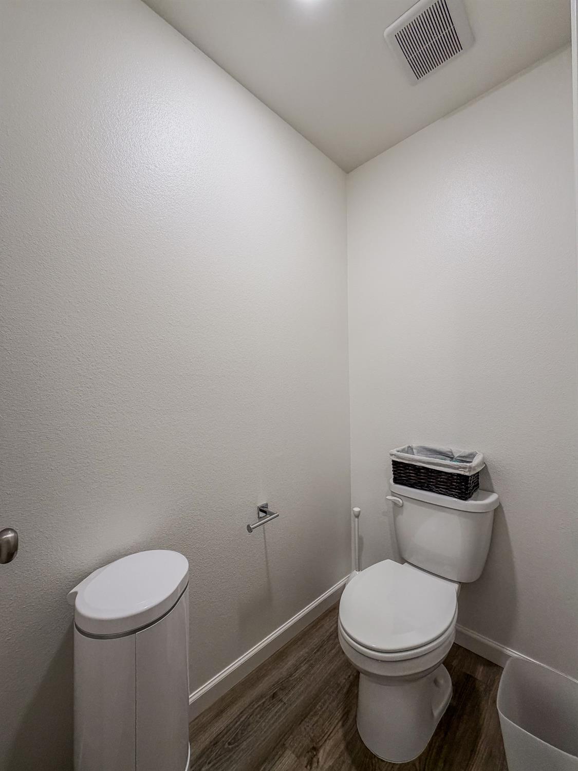 1451 Ryan Avenue Fowler, CA 93625 - Photo 15 of 23 a white toilet sitting next to a white wall