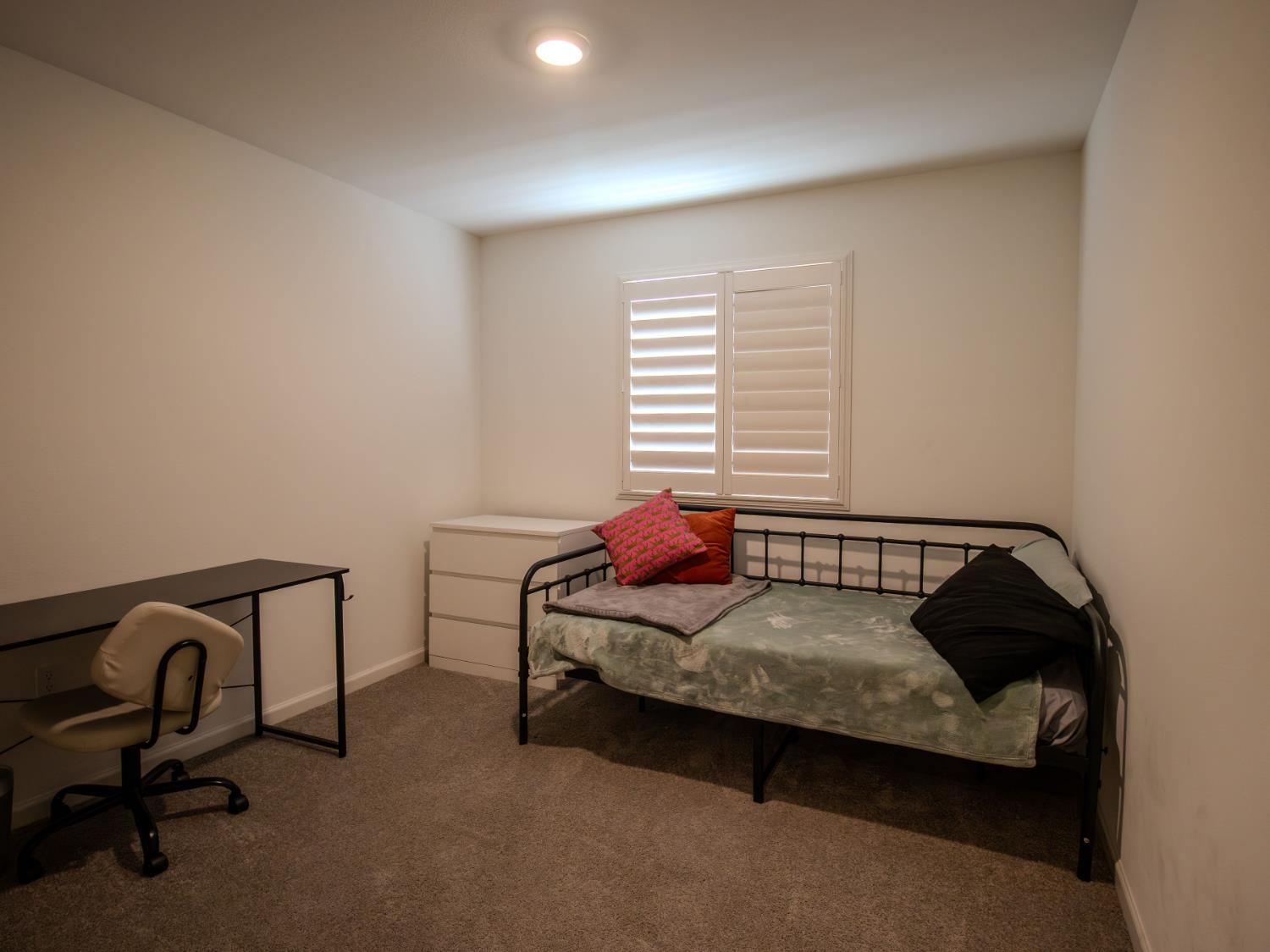 1451 Ryan Avenue Fowler, CA 93625 - Photo 19 of 23 a bedroom with a bed chair and a window
