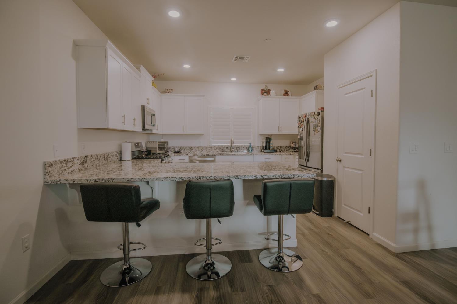 1451 Ryan Avenue Fowler, CA 93625 - Photo 5 of 23 a kitchen with stainless steel appliances granite countertop a stove a sink a refrigerator and a granite counter tops