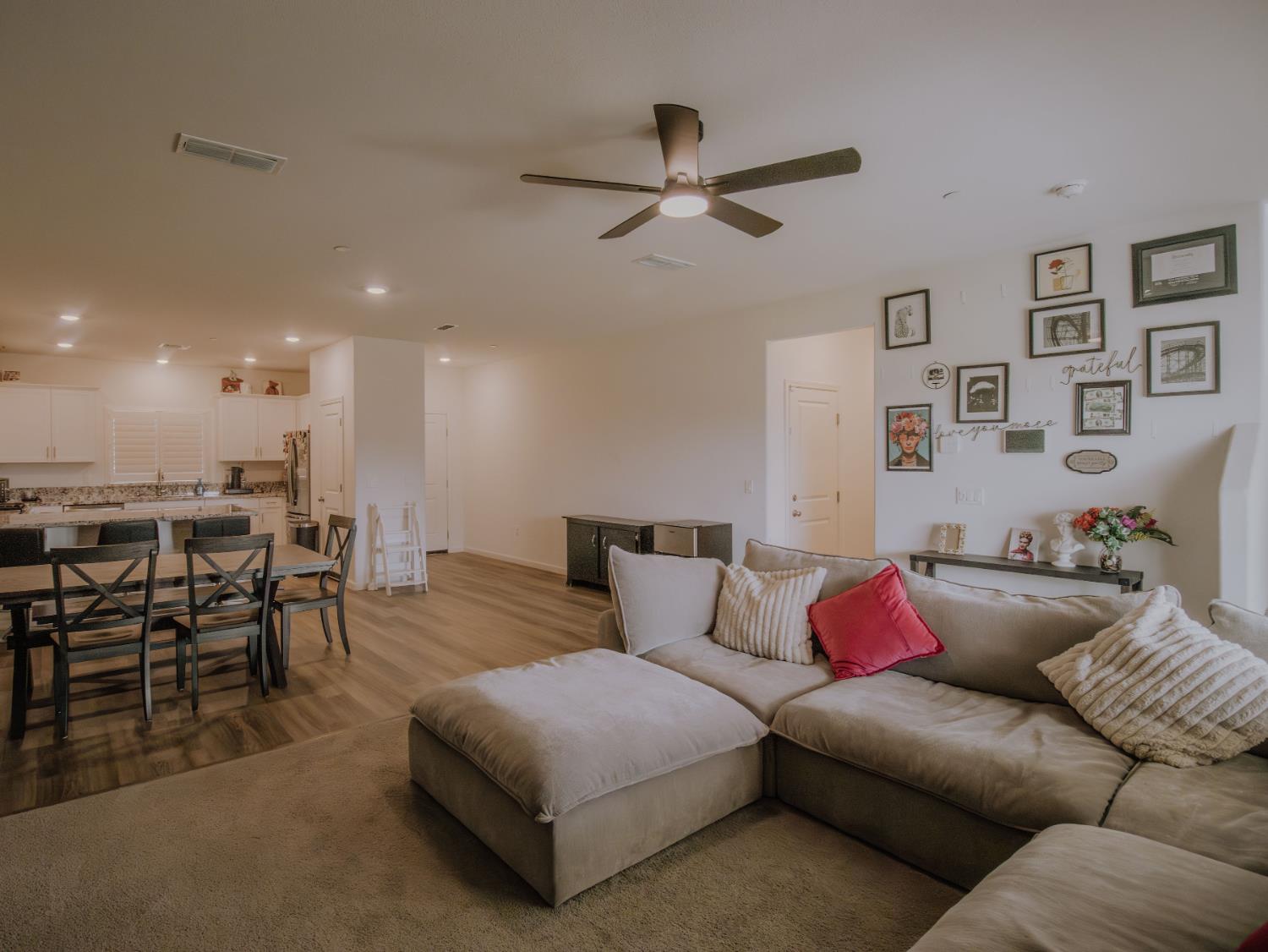 1451 Ryan Avenue Fowler, CA 93625 - Photo 6 of 23 a living room with furniture and kitchen view