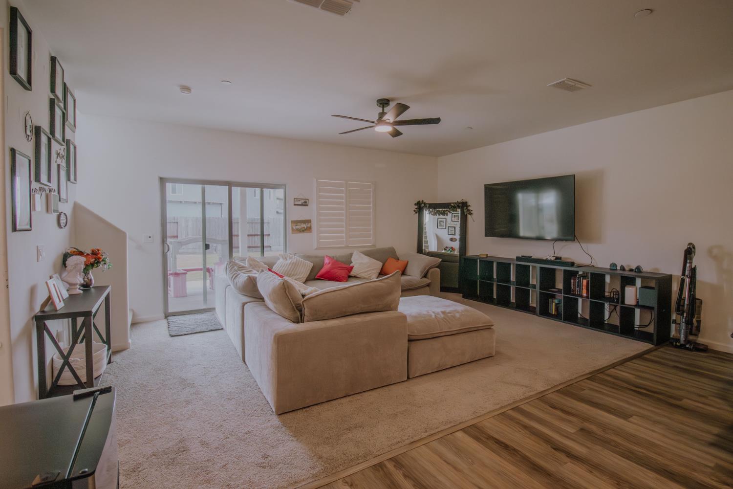1451 Ryan Avenue Fowler, CA 93625 - Photo 7 of 23 a living room with furniture and a flat screen tv
