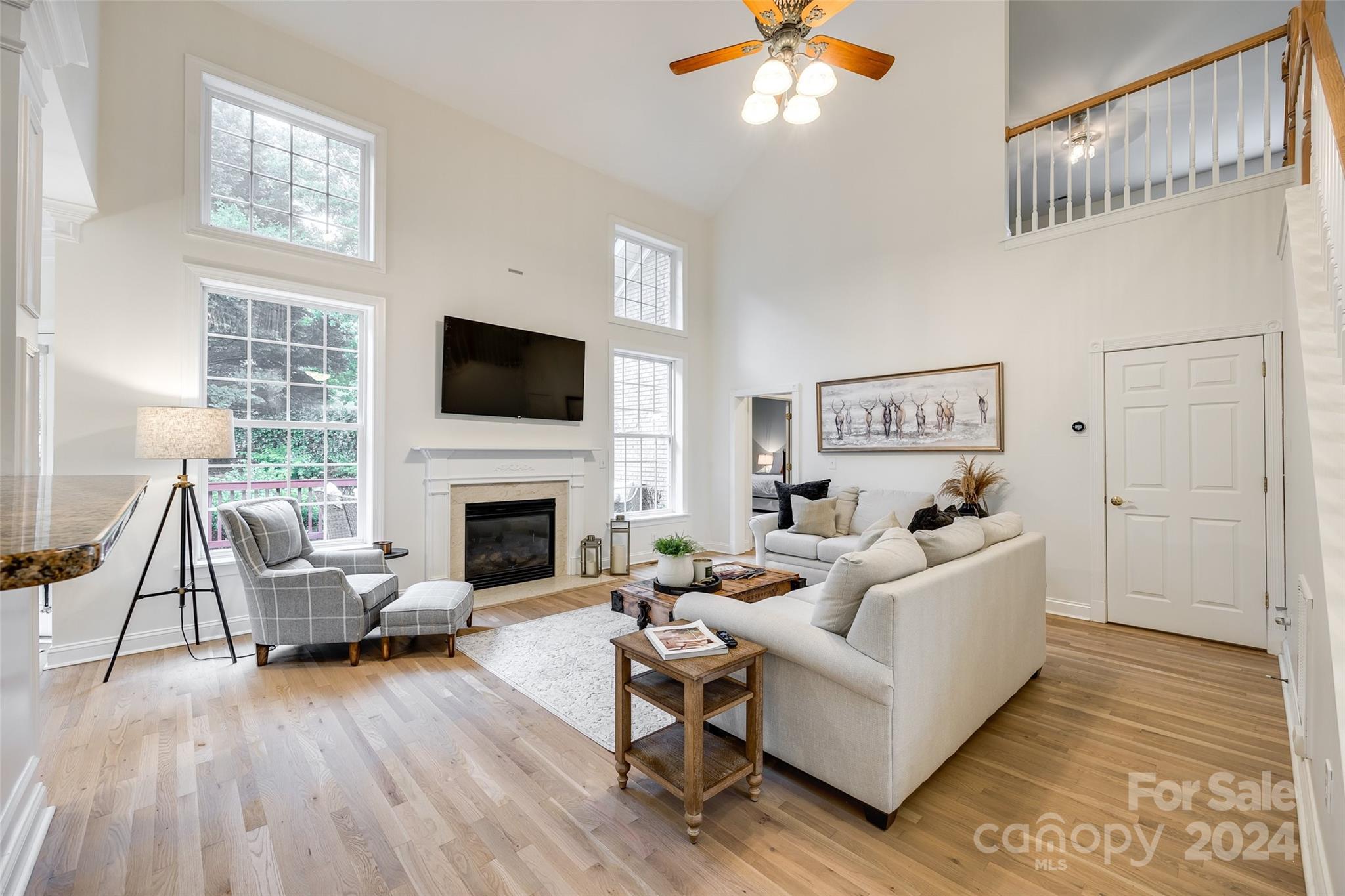 2004 Emerald Pines Drive Tega Cay, SC 29708 - Photo 12 of 30 a living room with furniture a fireplace and a flat screen tv