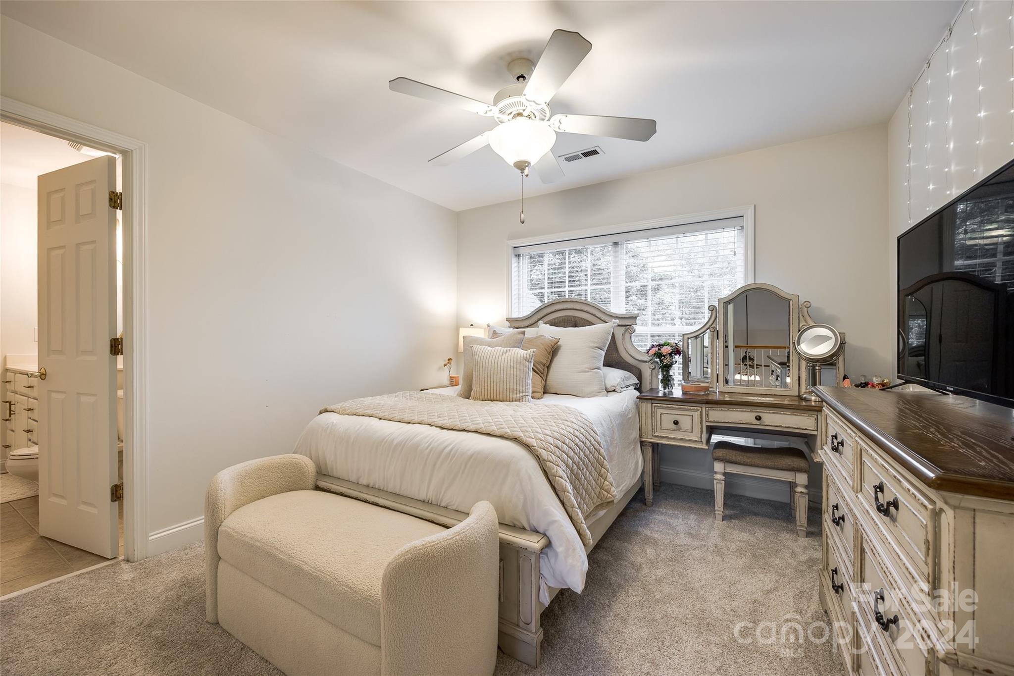 2004 Emerald Pines Drive Tega Cay, SC 29708 - Photo 23 of 30 a bedroom with a bed and a chandelier