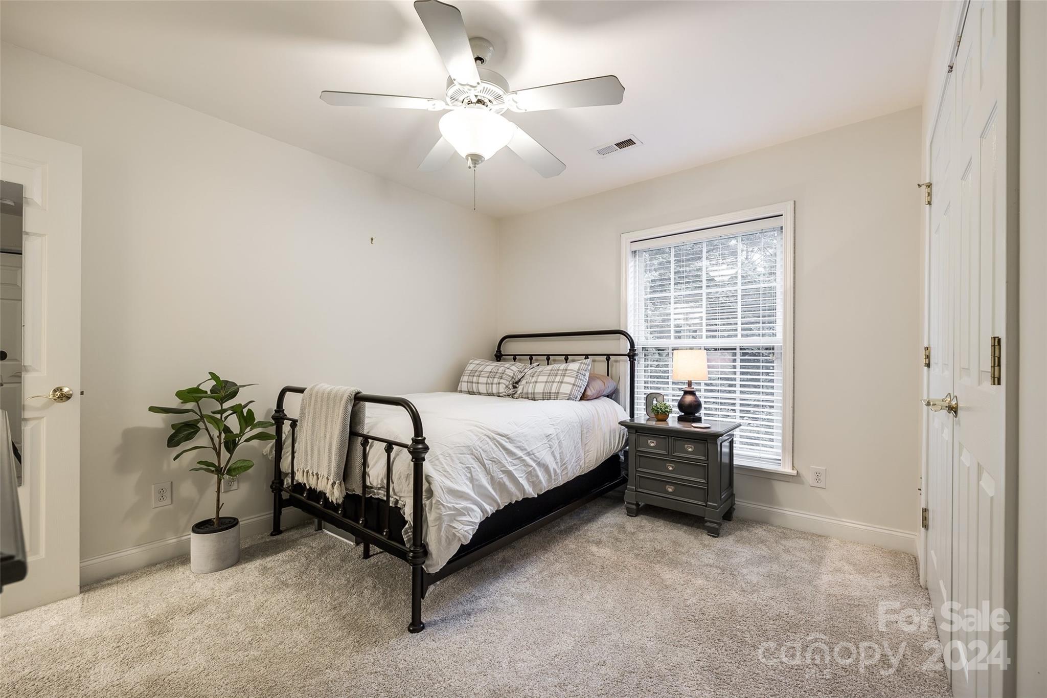 2004 Emerald Pines Drive Tega Cay, SC 29708 - Photo 25 of 30 a bedroom with a bed and a chandelier