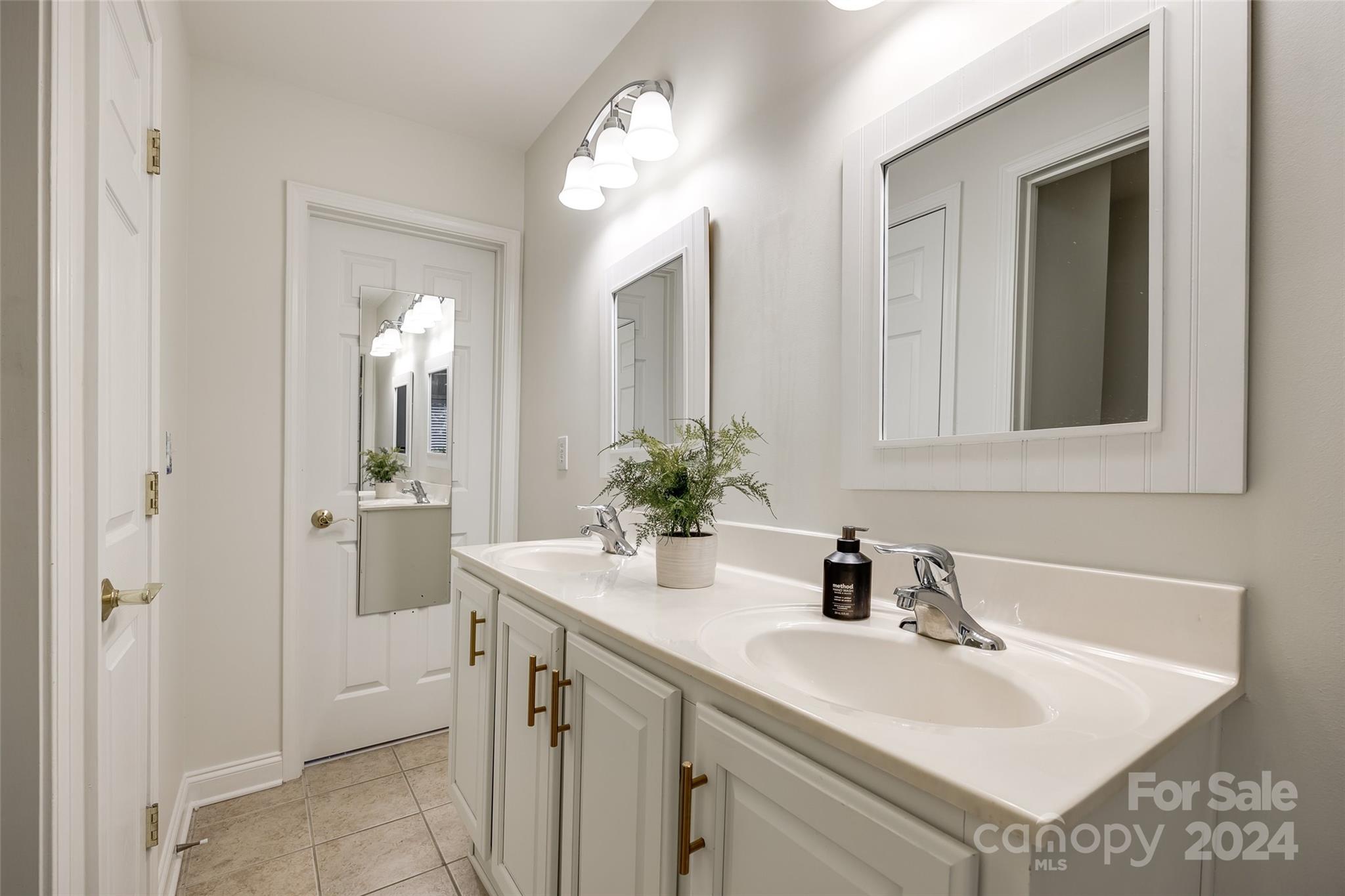 2004 Emerald Pines Drive Tega Cay, SC 29708 - Photo 27 of 30 a bathroom with a sink and a mirror