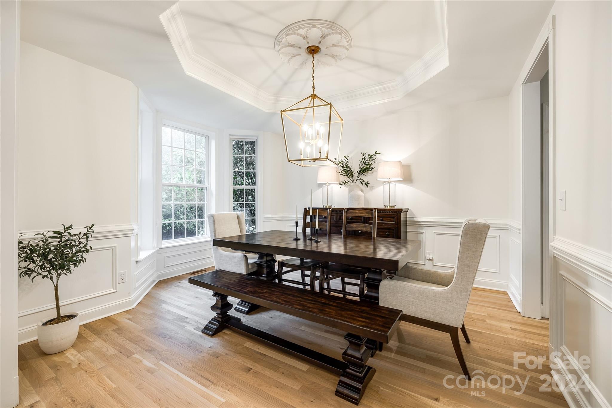 2004 Emerald Pines Drive Tega Cay, SC 29708 - Photo 4 of 30 a dining room with wooden floor and a chandelier