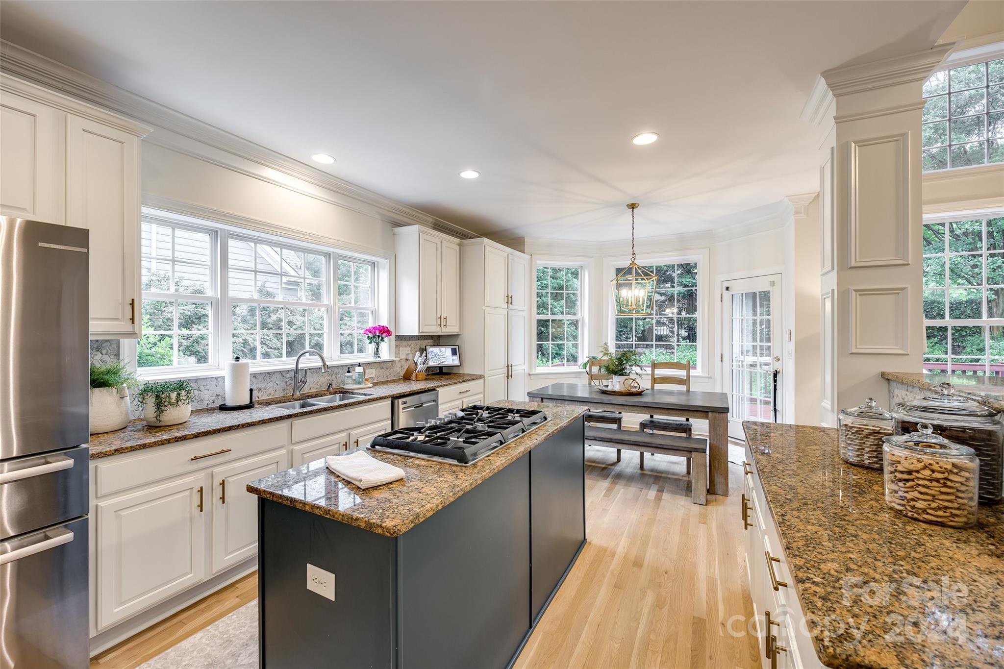 2004 Emerald Pines Drive Tega Cay, SC 29708 - Photo 7 of 30 a kitchen with counter top space a sink appliances and cabinets