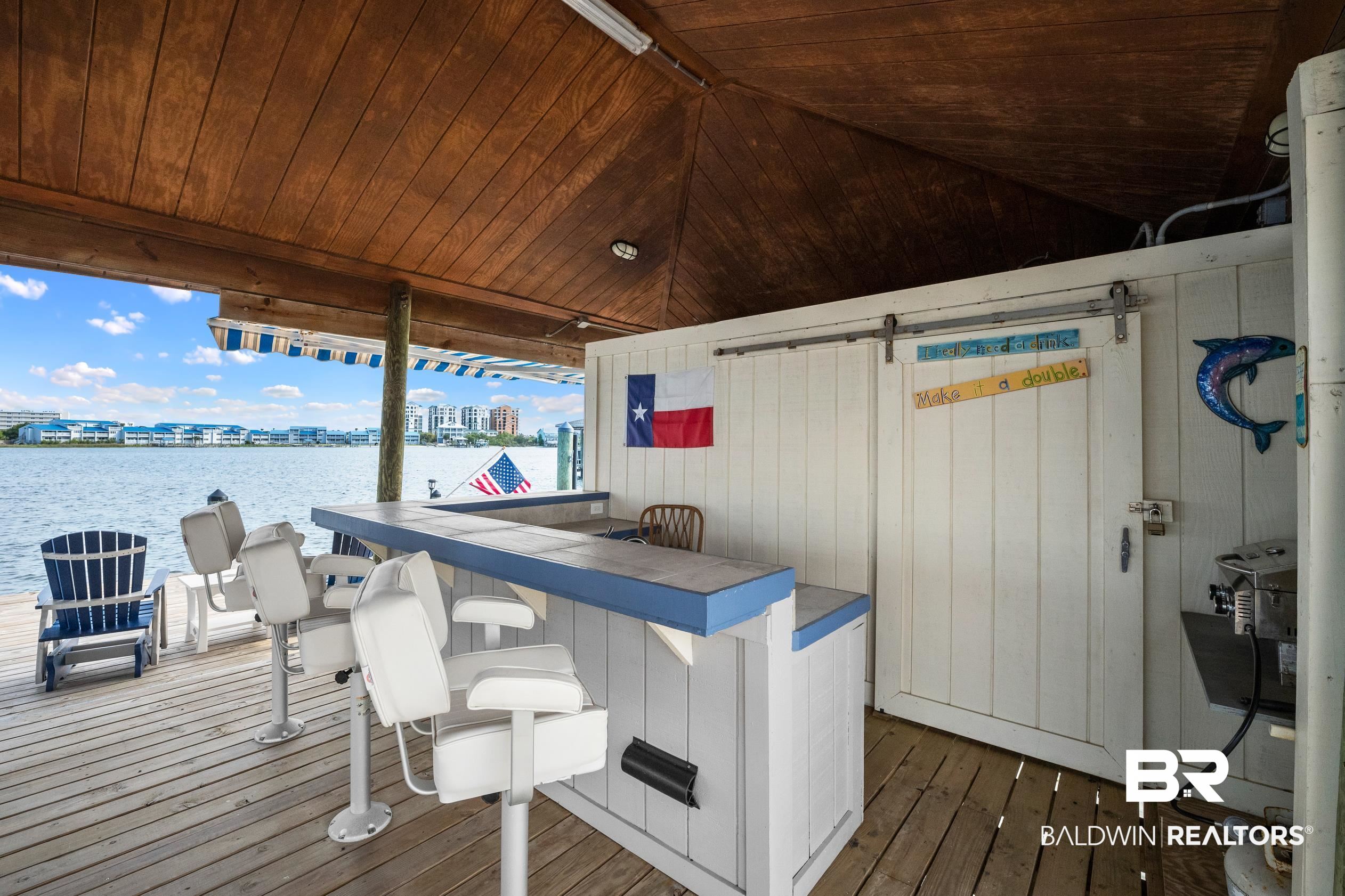 30954 River Road Orange Beach, AL 36561 - Photo 50 of 59 Deck featuring a water view and an outdoor bar