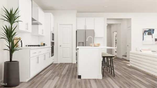 a kitchen with white cabinets and white appliances