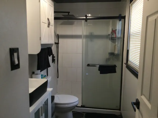 a bathroom with a sink a toilet and a mirror