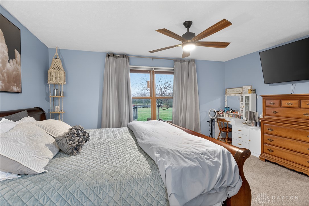 5264 Frazier-Guy Road Sidney, OH 45365 - Photo 22 of 51 This spacious bedroom offers ample natural light and comfortable carpeting throughout.
